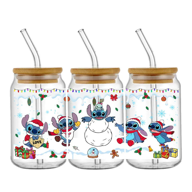 Three glass cups with bamboo lids, featuring a festive design of blue animated creatures in holiday attire, playing in snow, with gifts and decorations around them.
