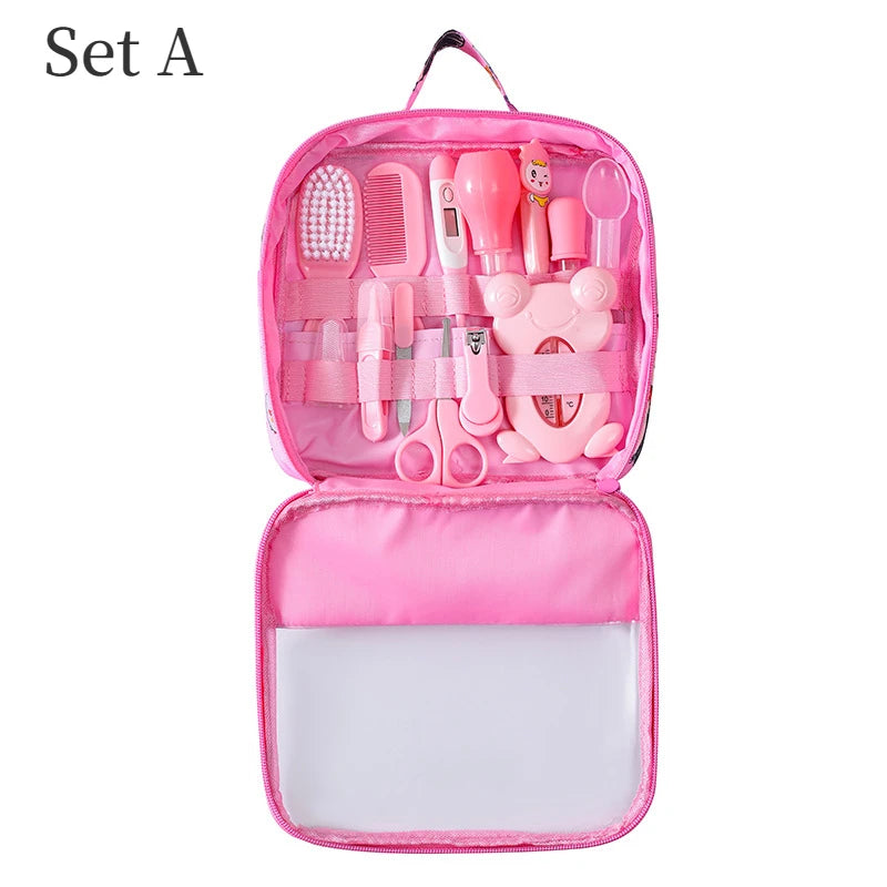 Pink baby care kit with various grooming tools, including a brush, comb, thermometer, nail clippers, scissors, and dropper, neatly organized in a zippered case labeled "Set A".