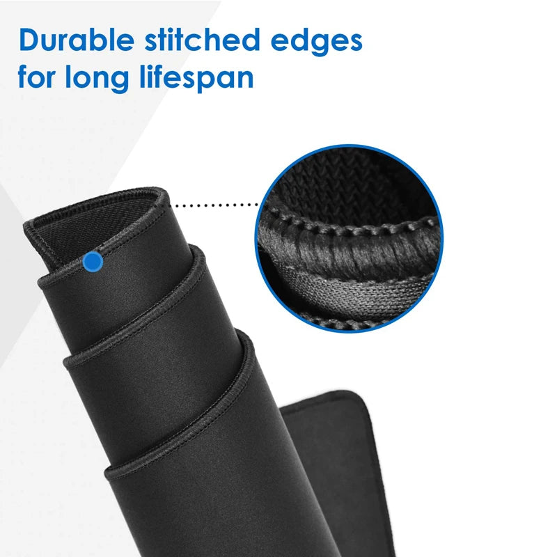 Close-up of a rolled-up black desk pad with durable stitched edges. A zoomed-in view highlights the stitching detail. Text reads: "Durable stitched edges for long lifespan."