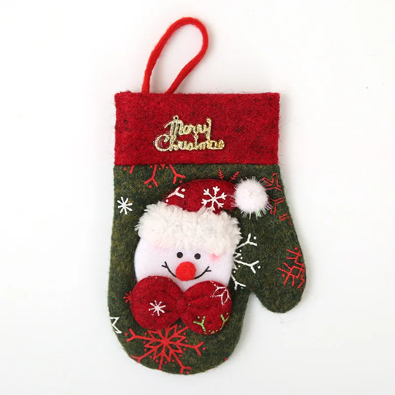 Christmas-themed decorative mitten with Santa's face, red top with "Merry Christmas" text, and snowflake patterns. Red hanging loop attached.