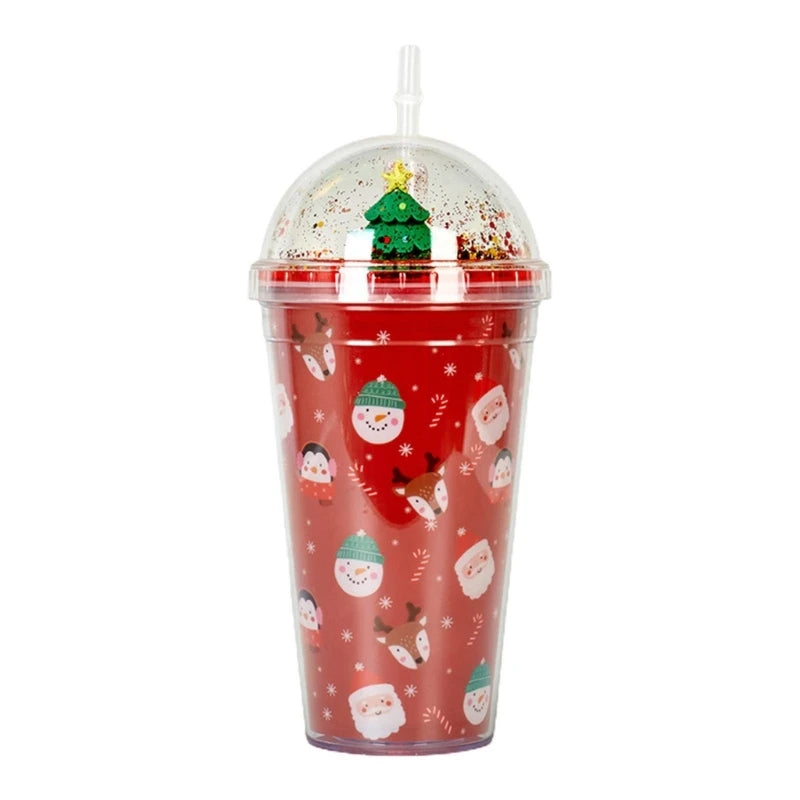 Red tumbler with Christmas-themed patterns, including snowmen, penguins, and reindeer. It has a clear dome lid featuring a green Christmas tree inside, topped with a straw.