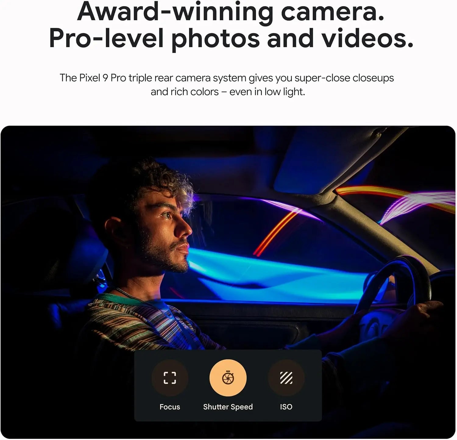 A person in a car is illuminated by colorful lights, showcasing a camera's ability to capture vibrant colors and details in low light. On-screen controls for focus, shutter speed, and ISO.