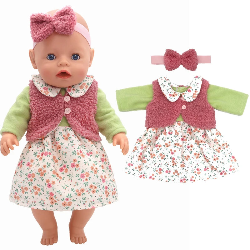 A baby doll wearing a floral dress with a green long-sleeve top and pink fuzzy vest. The outfit is accessorized with a matching pink bow headband, shown next to a similar clothing set.