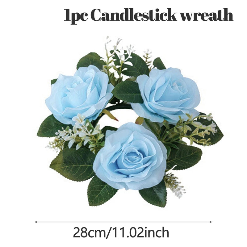 Candlestick wreath with three light blue roses, green leaves, and small white flowers, measuring 28 cm (11.02 inches) in diameter.