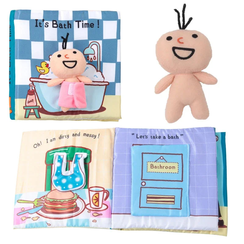 Children's soft book with a detachable plush doll. The book features colorful pages with illustrations of bathing, meals, and a door labeled "Bathroom."