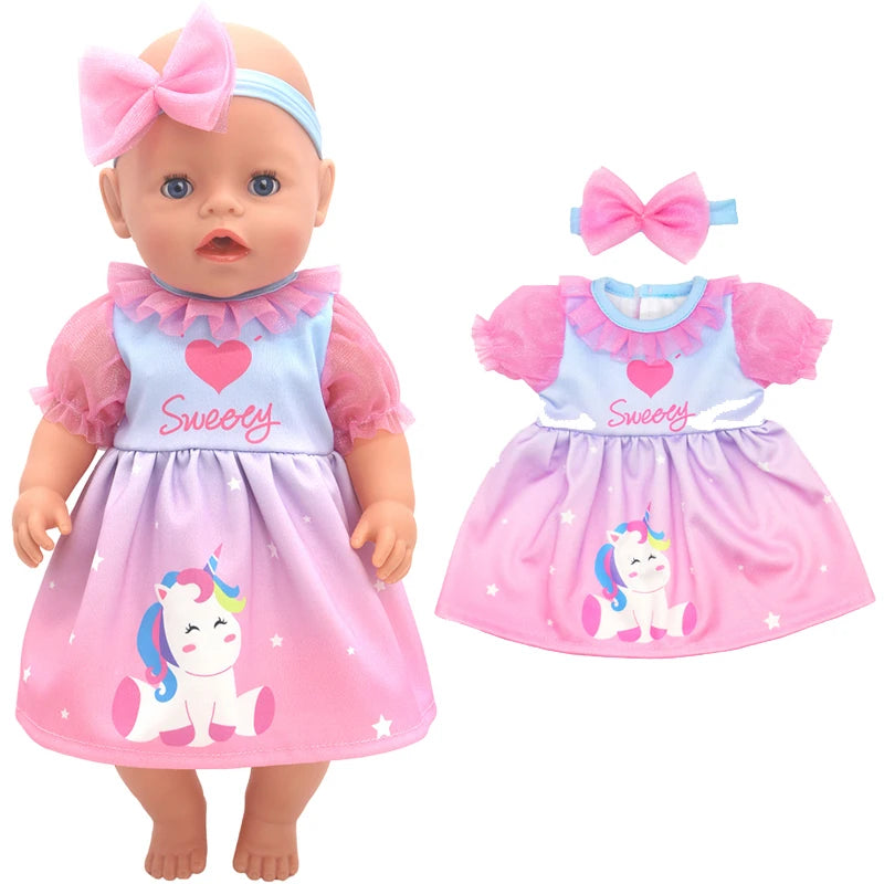 Baby doll in a colorful dress with "Sweety" text and unicorn design. Includes a pink headband with a bow. Matching dress ensemble shown alongside the doll.