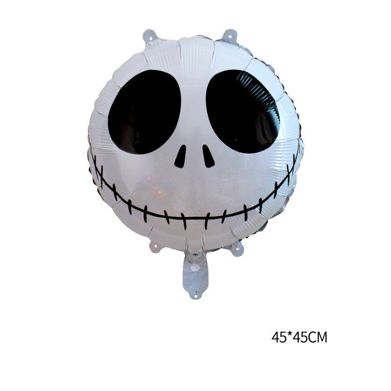 Round foil balloon with a white and black skull design, featuring large black eyes and a stitched smile. Text "45*45CM" is displayed.