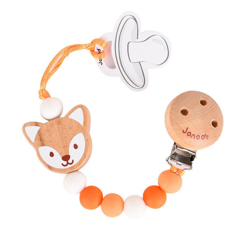 A pacifier clip featuring a wooden fox head, orange and white beads, and a wooden clip labeled "Janod." It's linked to a pacifier via an orange loop.