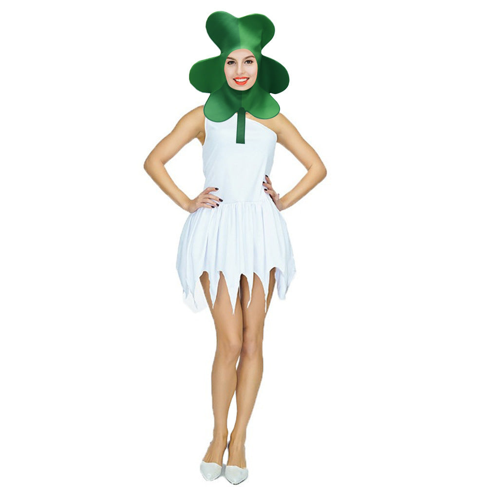 Person in a white dress and a green clover headpiece stands with hands on hips, smiling. The skirt is jagged, and they wear white shoes, appearing against a white background.