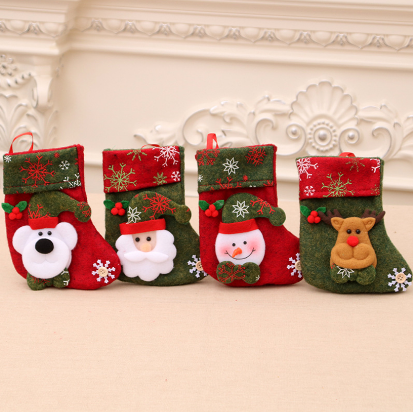 Four festive Christmas stockings in red and green, each adorned with different felt figures: a bear, Santa, a snowman, and a reindeer, set against an ornate cream background.