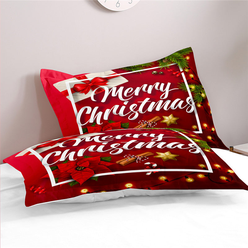 Red "Merry Christmas" bedding set with holiday motifs like poinsettias, candy canes, and stars, adorned with festive lights and greenery on a white bed.