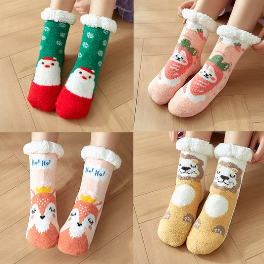 Four pairs of fuzzy socks with festive designs: green with Santa, pink with strawberries, peach with a deer, and yellow with a lion. They have cozy white cuffs.