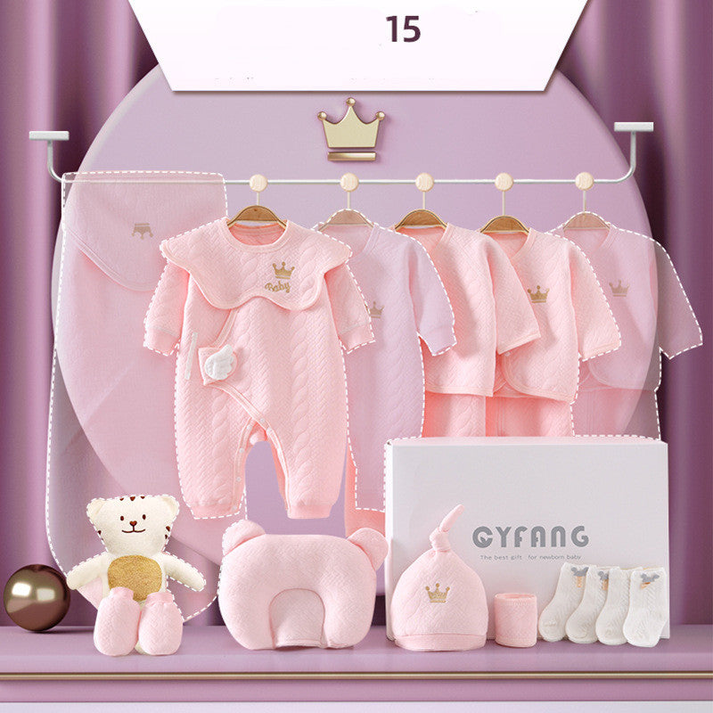 Pink baby clothing set with onesies, cardigans, a teddy bear, hat, and mittens. The outfits feature a crown motif, and a white box labeled "GYFANG" is included.