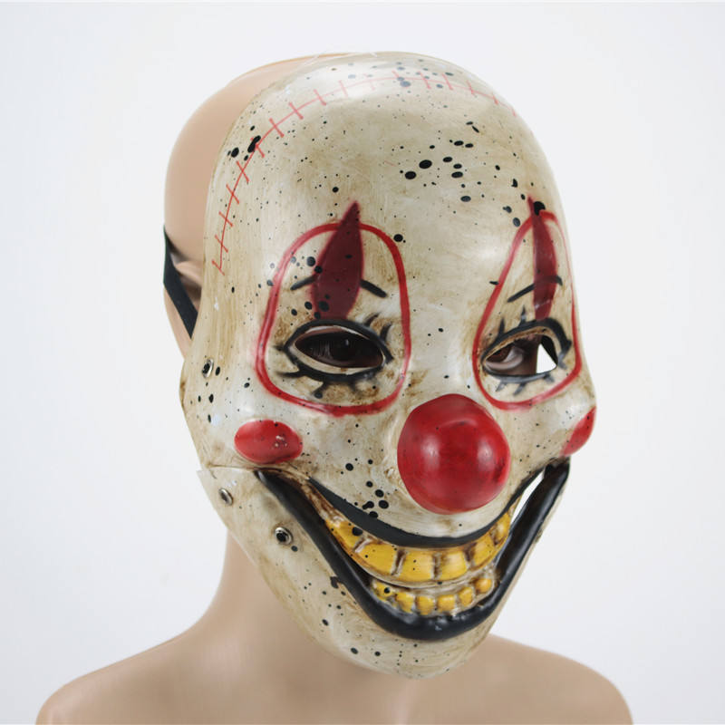 Creepy clown mask with exaggerated smile, red nose, and sinister eyes. Dirty white surface with red accents and stitched forehead details, giving a menacing expression.