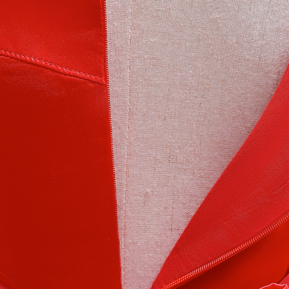 Close-up of a fabric panel, featuring vibrant red material with stitching and a contrasting light gray section. The texture and colors create a striking, geometric pattern.