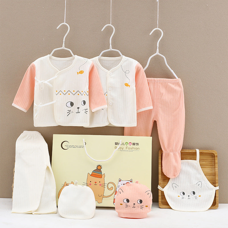 Two sets of baby clothes with pink and white cat designs hang on hangers. Accessories include a hat, mittens, and bib, with a gift box featuring a cat illustration below.