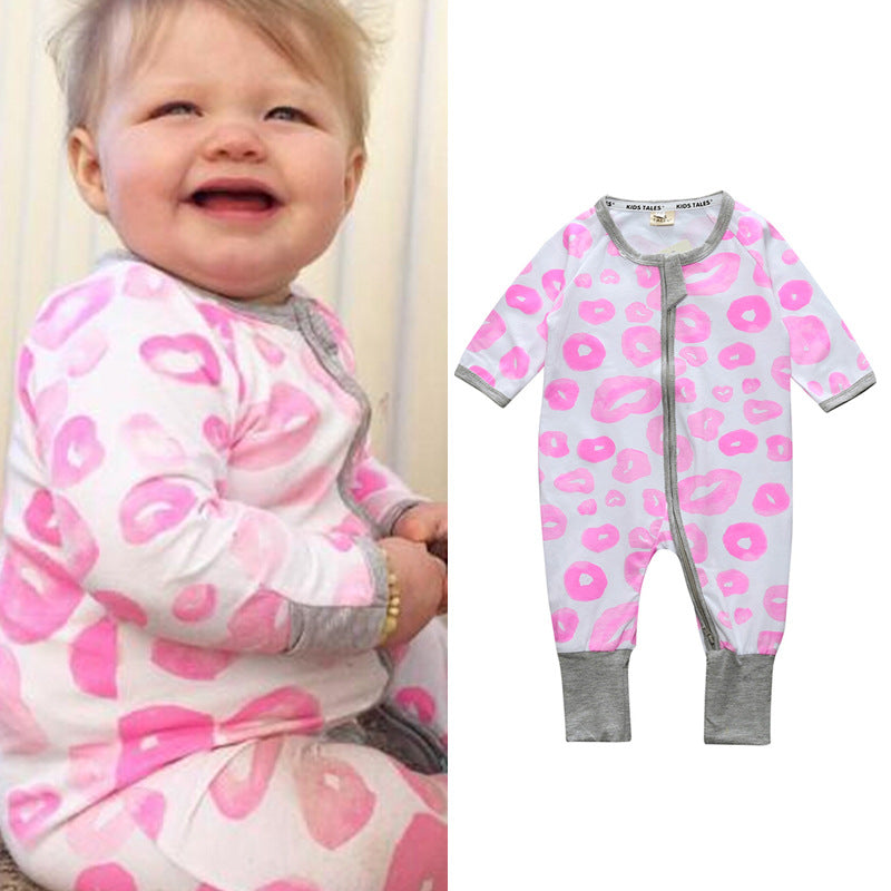 Smiling baby wearing a white onesie with pink lip prints and grey trim; identical outfit shown on the right, laid flat to display full design.