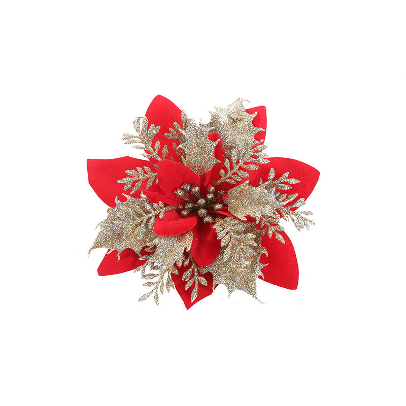Red poinsettia ornament with golden glittery leaves and delicate branches, arranged in a festive, symmetrical design. Set against a plain white background.