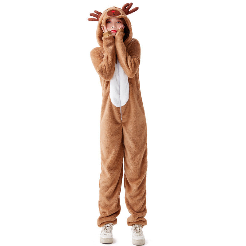 Person in a cozy reindeer onesie with antlers and a red nose, standing on a white background. They have their hands near their face and wear white sneakers.
