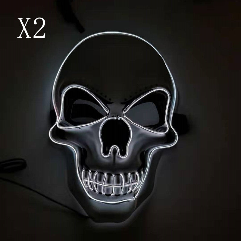 A black skull with glowing white neon outlines and hollow eyes and nose on a dark background. The number "X2" is in the upper left corner.