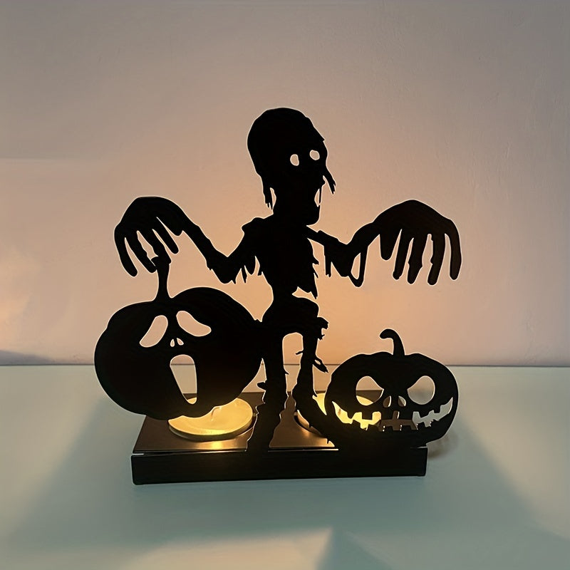 Silhouette of a zombie with outstretched arms between two jack-o'-lanterns on a lit base, casting eerie shadows on a plain background.