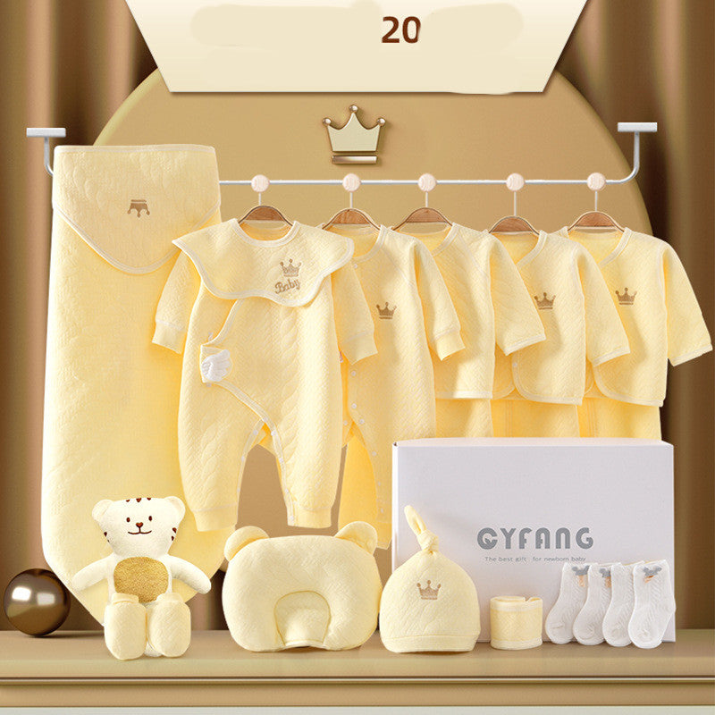 Yellow baby gift set with clothing, a onesie, jacket, socks, hat, pillow, blanket, and plush bear. Items are neatly arranged with a gift box labeled “GYFANG.”