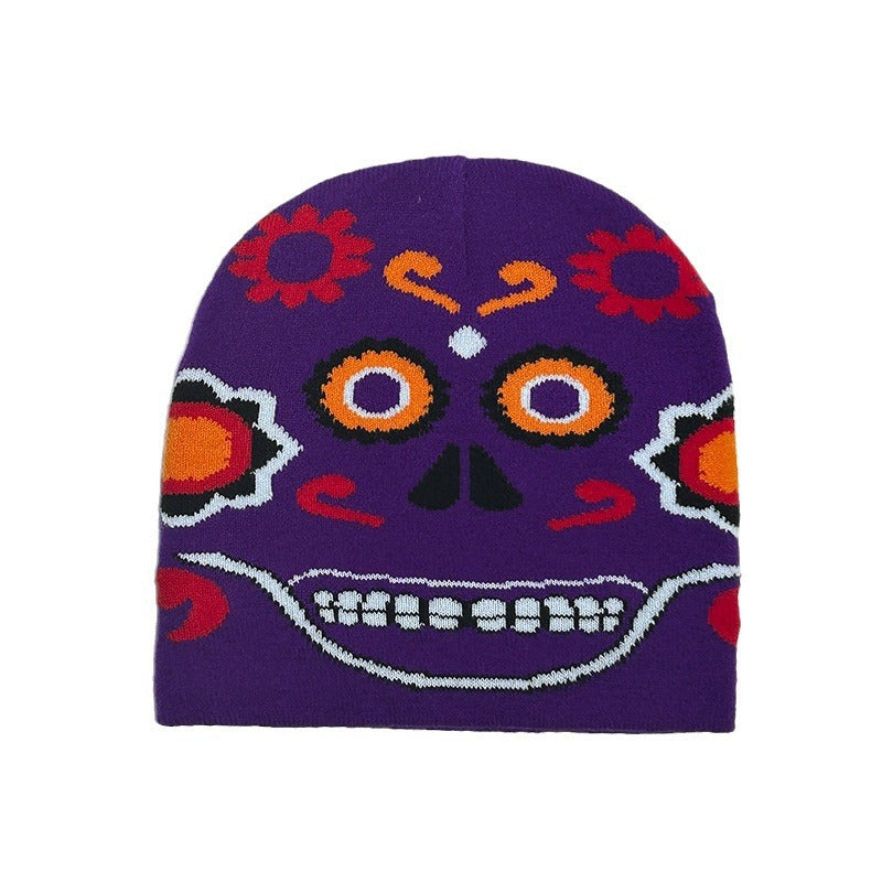 Purple beanie featuring a colorful Day of the Dead skull design with vibrant orange, red, and white patterns, including flowers and swirling details.