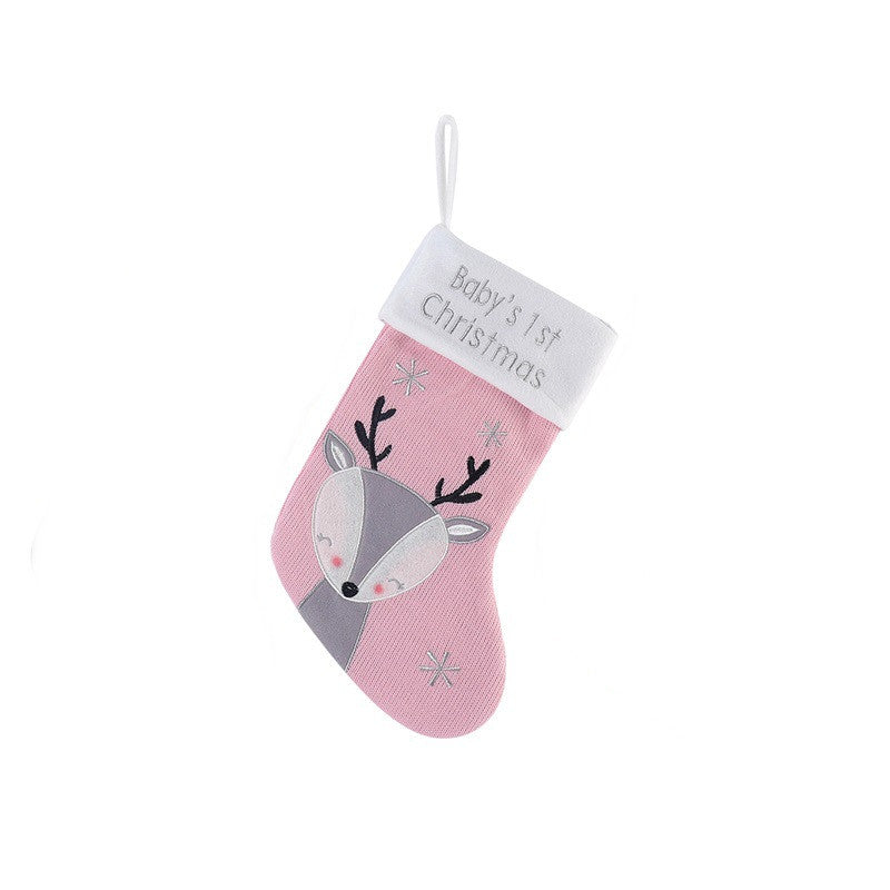 Pink Christmas stocking with a reindeer design and snowflakes, featuring a white cuff with "Baby's 1st Christmas" embroidered.