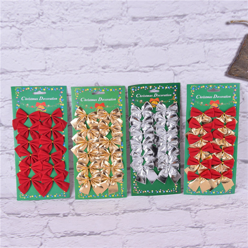 Four green cards labeled "Christmas Decoration" display festive bows in red, gold, silver, and a combination of red and gold, set against a white brick wall.