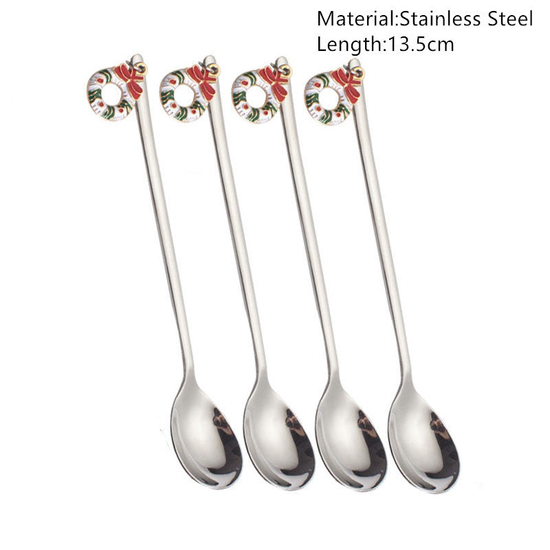 Four stainless steel spoons, each 13.5cm long, featuring festive wreath designs with red and green bows on the handles against a white background.