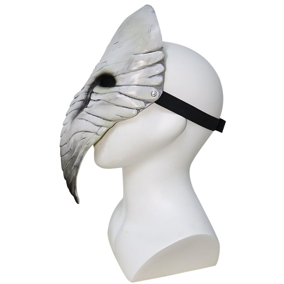 Side view of a white mannequin wearing a silver, bird-like plague doctor mask with a long beak and textured details, secured with a black strap around the head.
