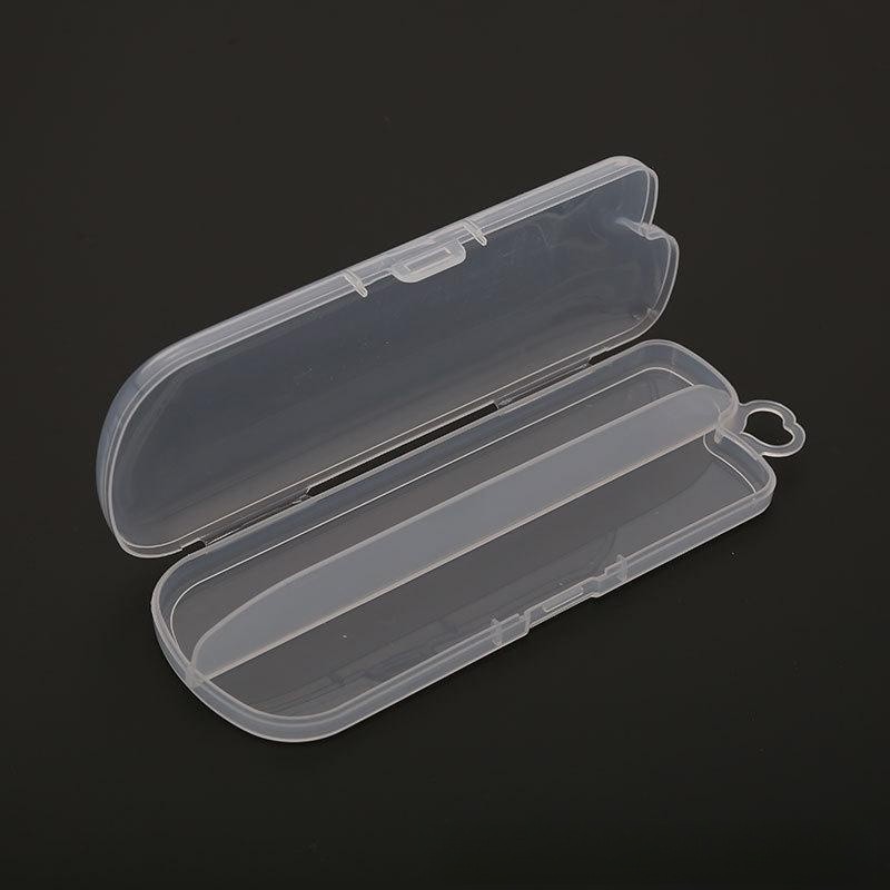 Transparent plastic toothbrush case, open, with a clasp at the top and a heart-shaped handle loop on the side, displayed on a dark background.