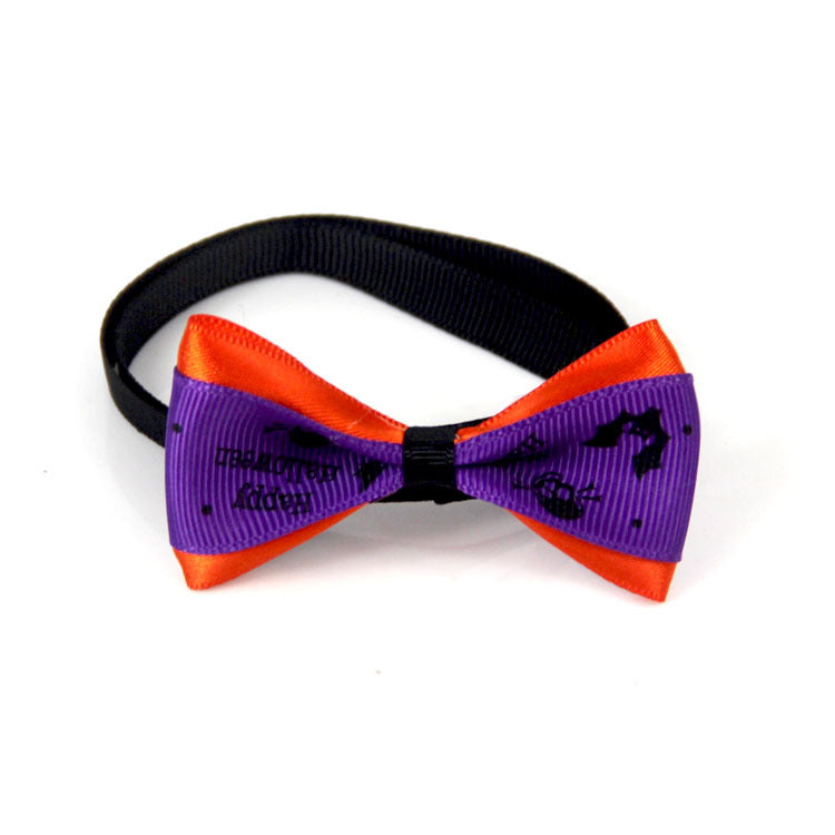 Purple and orange Halloween-themed bow tie with black bat and pumpkin designs, attached to a black elastic band.