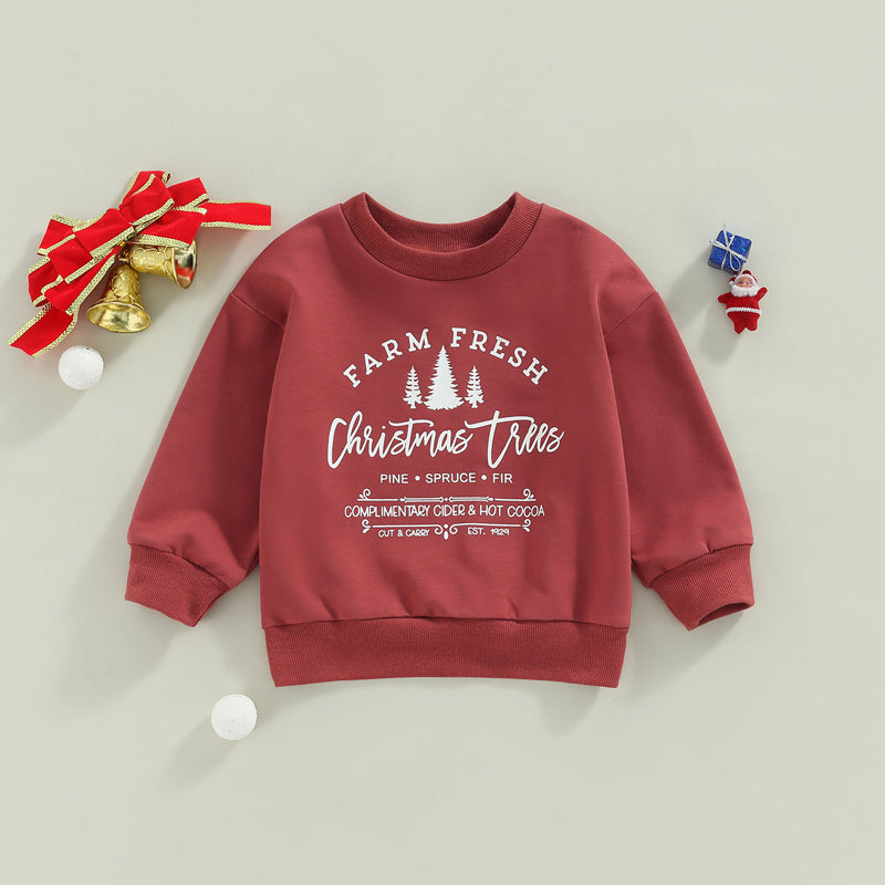 Red Christmas-themed sweatshirt with white text, "Farm Fresh Christmas Trees," and icons. Decorated with bells, red ribbon, and small gifts on a light background.