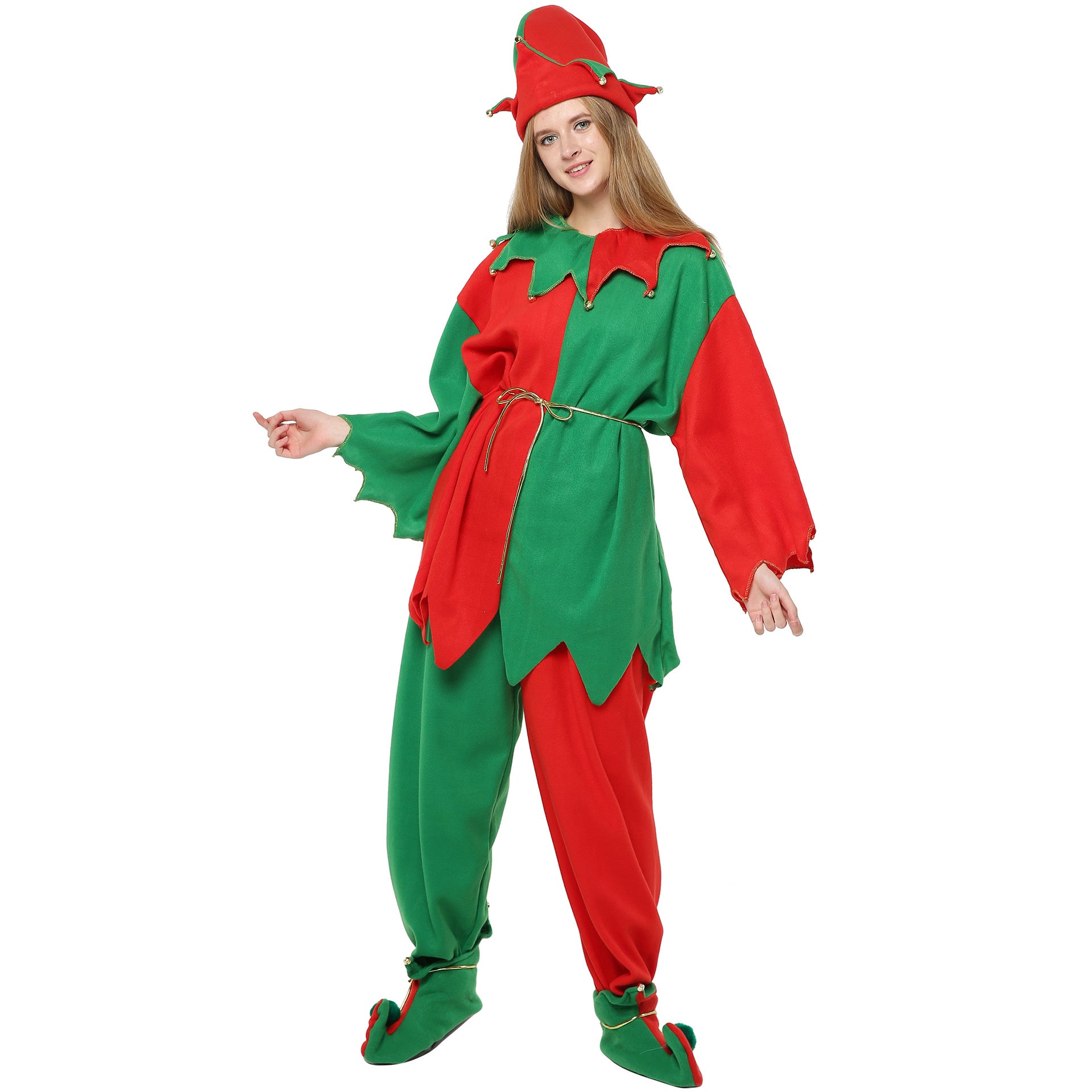 A person wearing a vibrant red and green elf costume with a pointed hat and curled shoes, featuring jingle bells and a rope belt. They're smiling and posing playfully.