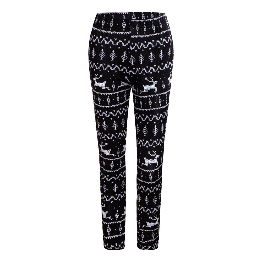 Black leggings featuring white Nordic patterns with reindeer and trees.