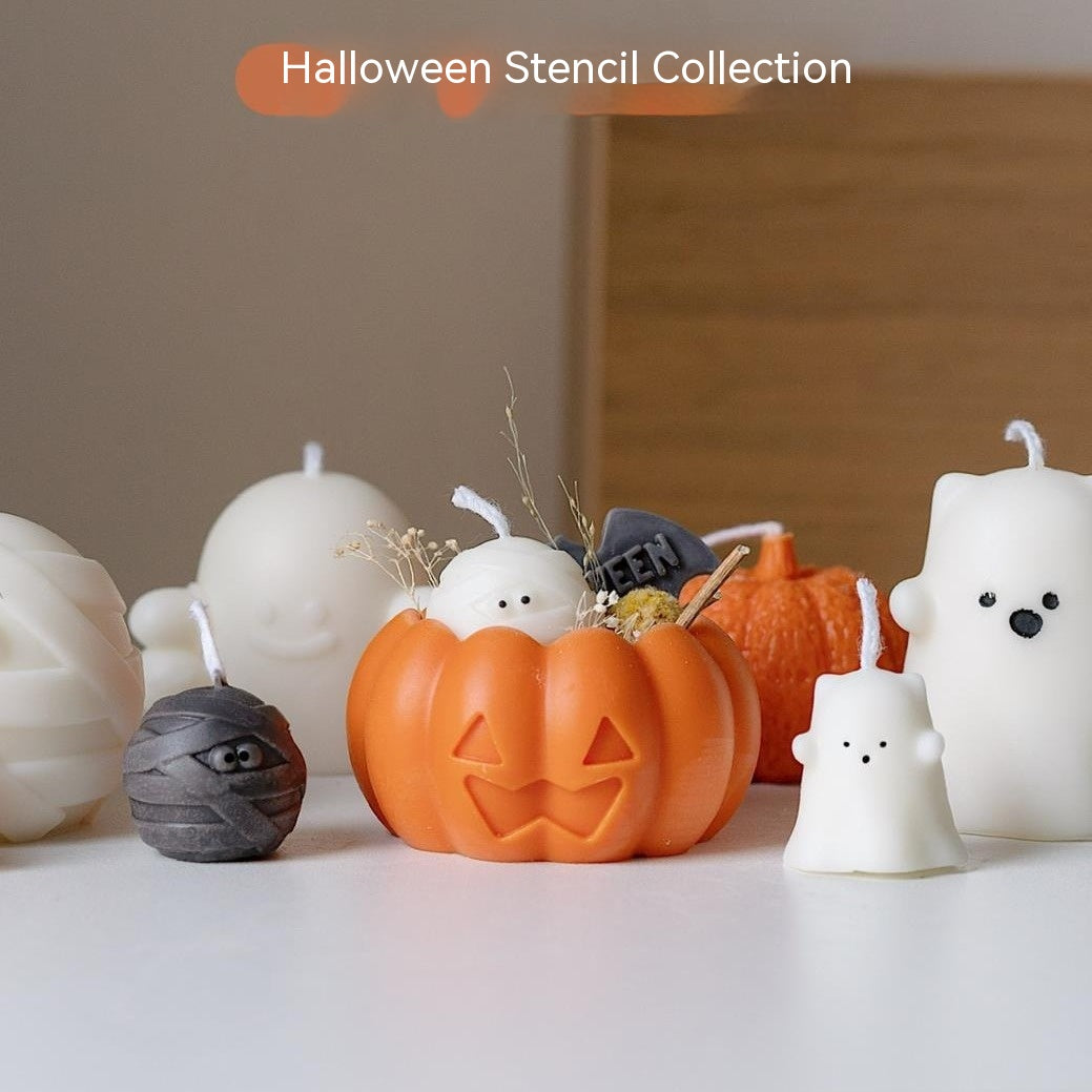 Cute Halloween-themed candles featuring a pumpkin, ghost, mummy, and bear arranged on a table. Text above reads "Halloween Stencil Collection."