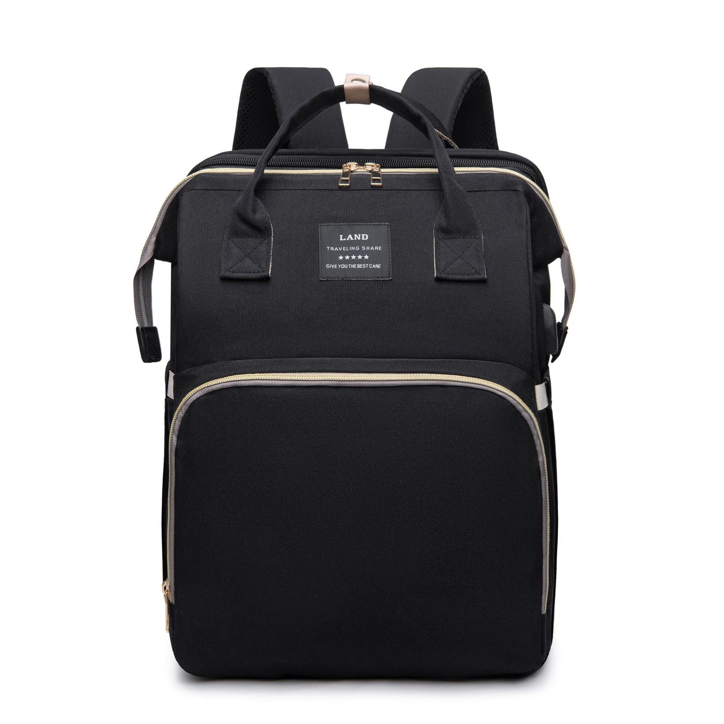 Black backpack with beige zippers, front pocket, and handles. Features a square label on the front. Designed for travel with padded shoulder straps and compact shape.