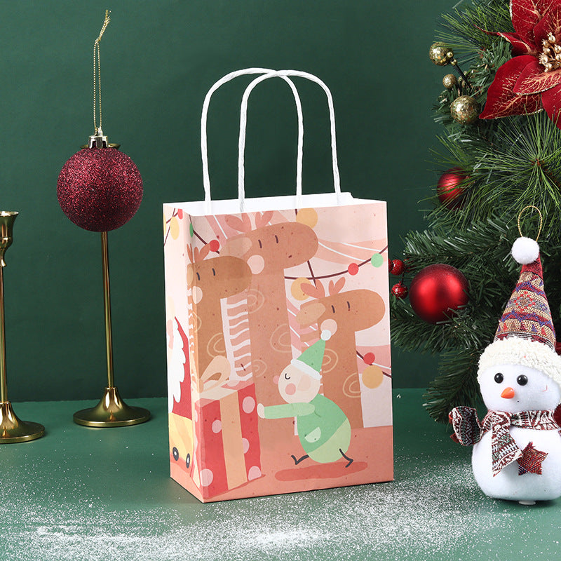 Christmas-themed scene with a decorated gift bag featuring reindeer, a snowman in a knitted hat and scarf, a festive tree with ornaments, and a red glittery bauble on a stand.
