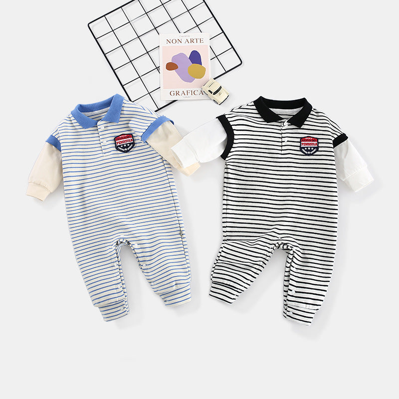 Two striped baby rompers, one blue and white, the other black and white, with collar and badge, on a white background. Nearby are a toy car and art-themed cards.