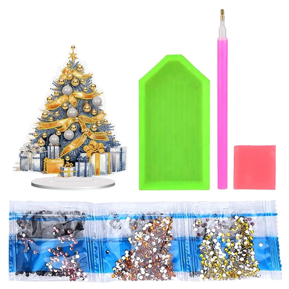 Christmas tree diamond painting kit with a decorated tree, multicolored rhinestones, a pink stylus, green tray, and wax square for crafting.