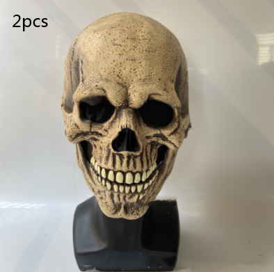 Realistic beige skull mask with dark eye sockets displayed on a black stand, featuring detailed textures and visible teeth. Text “2pcs” is seen in the top left corner.