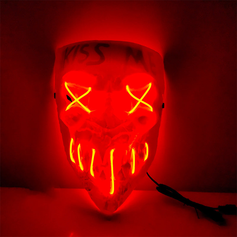 Red neon mask with glowing X-eyes and fanged mouth, with "Kiss Me" written across the forehead. The design is dramatic and eye-catching, creating an eerie effect.