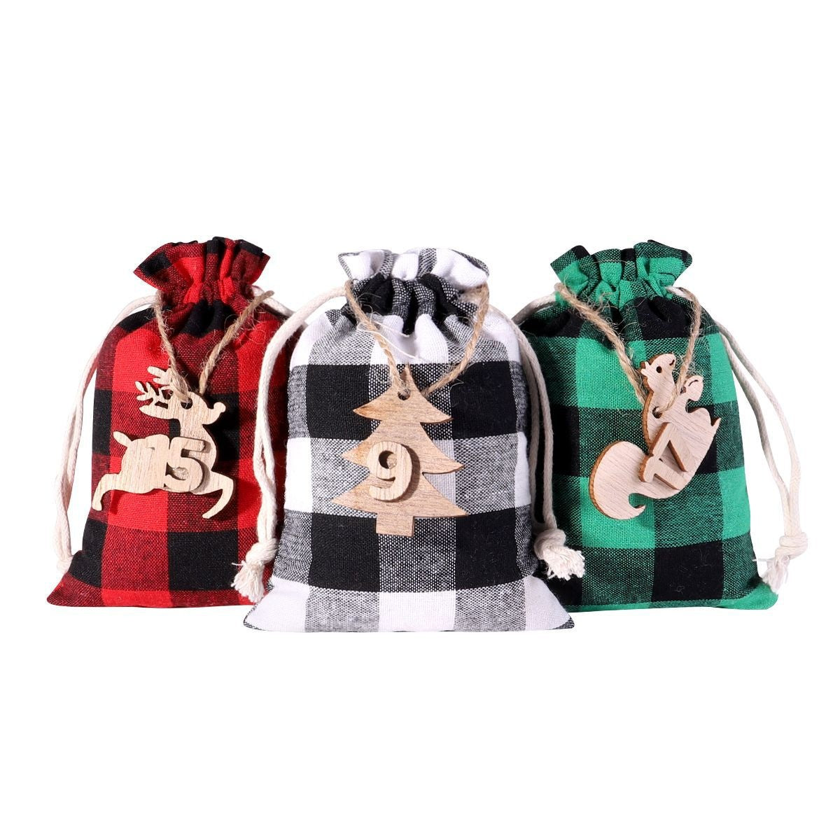 Three plaid drawstring gift bags in red, black, and green, with wooden Christmas-themed ornaments featuring a reindeer, tree, and squirrel attached by twine.