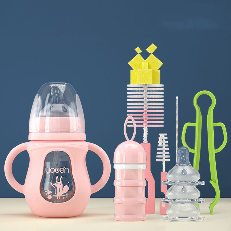 Pink baby bottle with handles, accompanied by cleaning brushes, a green tong, stacked bottle caps, and a pink container, set against a blue background.