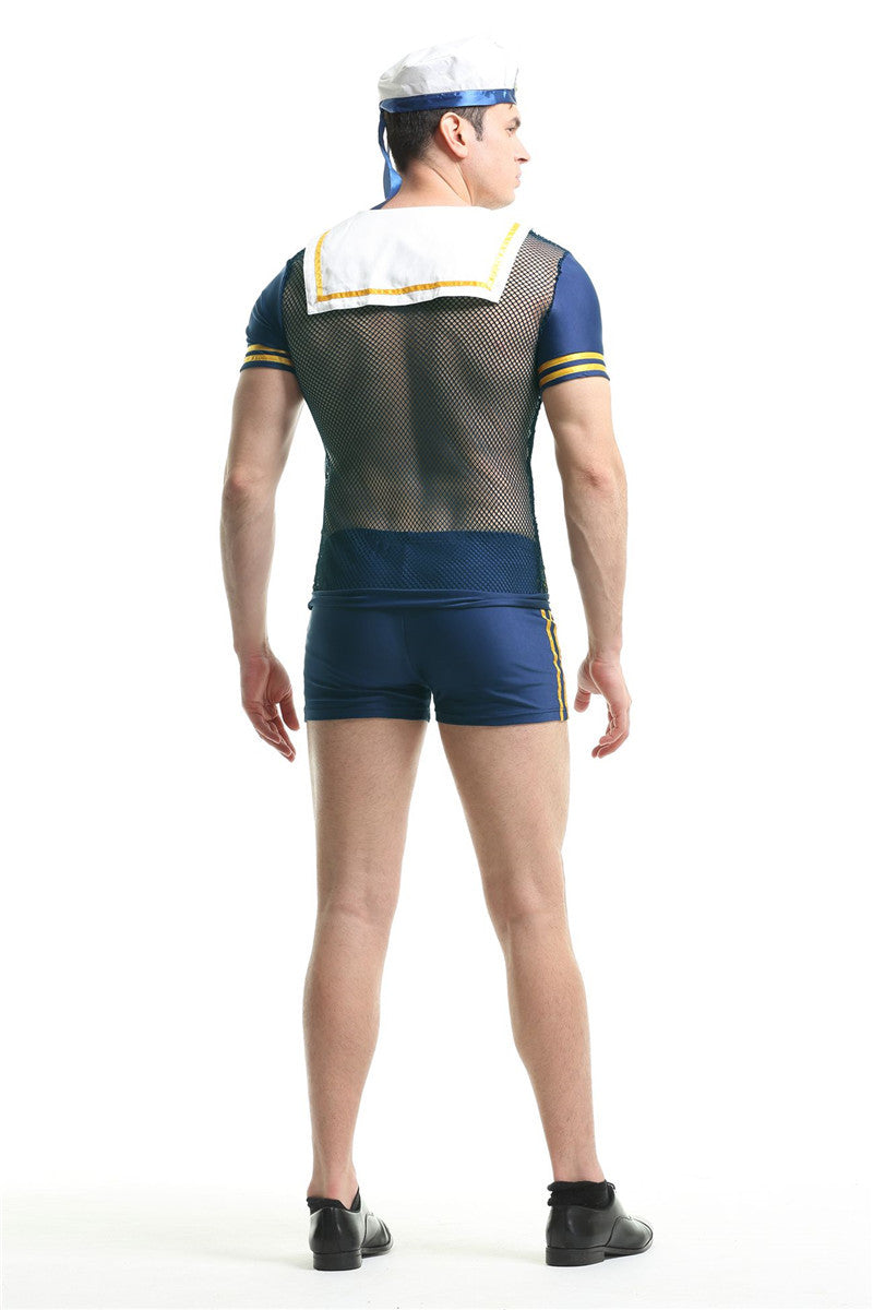 Rear view of a man in a sailor-themed costume with a mesh top, shorts, and a hat, facing left. The outfit includes yellow-striped details and black shoes.