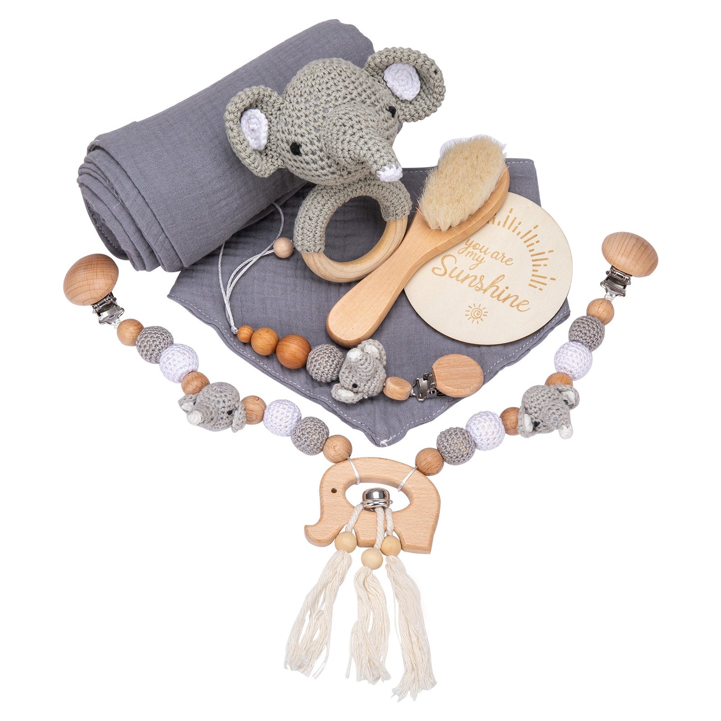 Gray baby blanket set with a crocheted elephant rattle, wooden brush, and pacifier clip adorned with beads and stuffed elephants. Round plaque reads "You are my Sunshine."