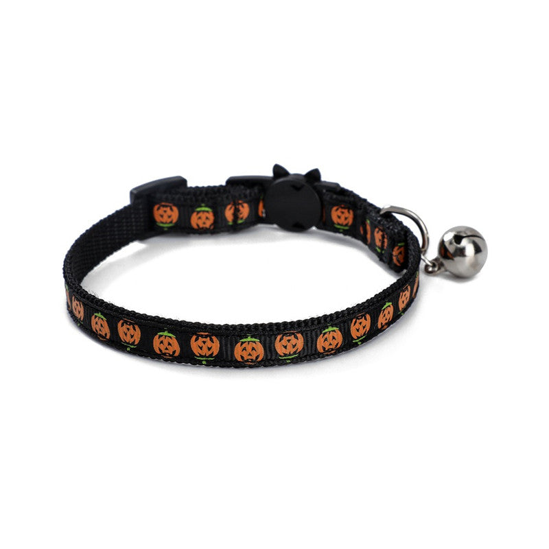 Black cat collar decorated with orange pumpkin faces, featuring a small silver bell and a black buckle, designed for Halloween-themed pet wear.