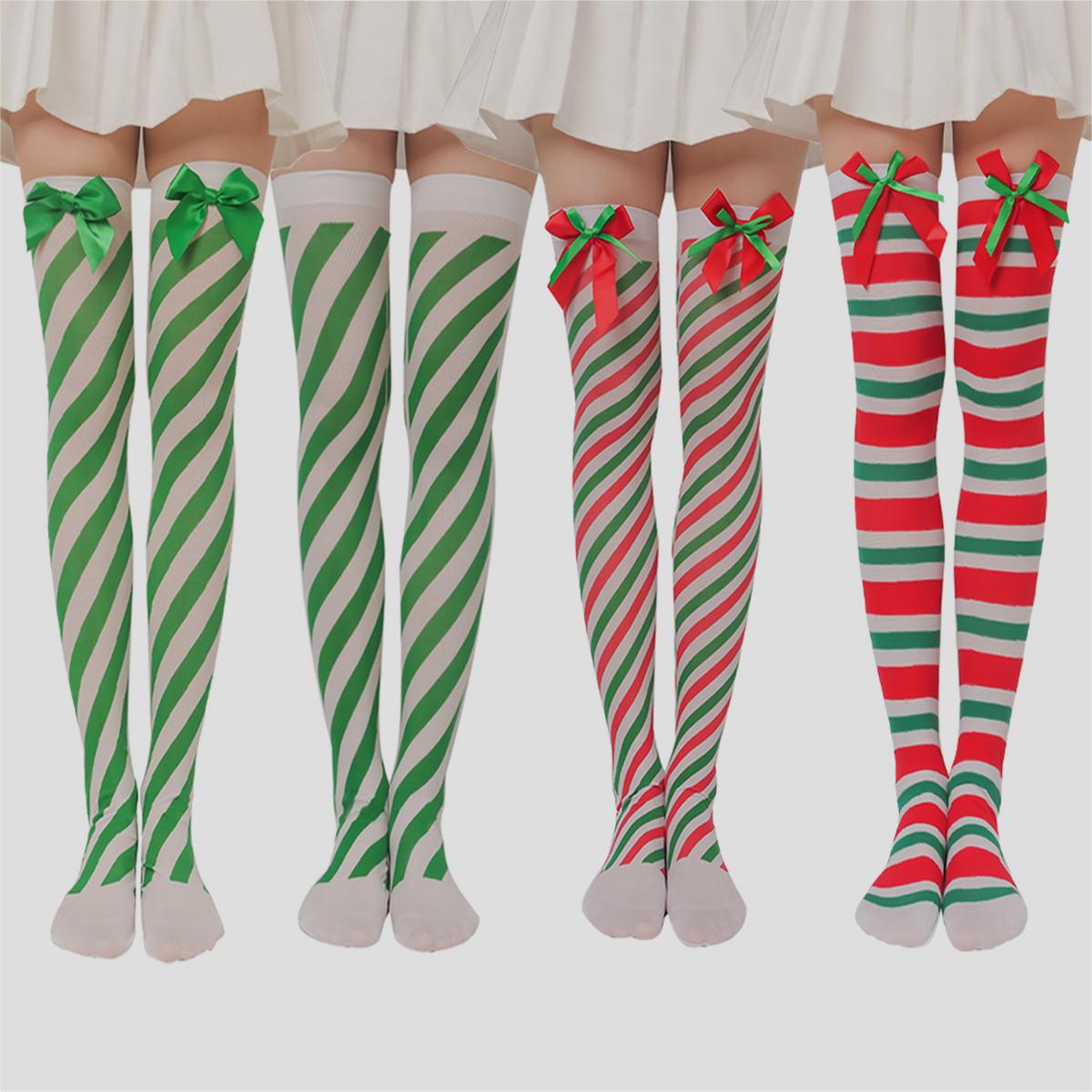 Four pairs of legs wearing thigh-high striped stockings with holiday colors. Two pairs of green and white, one red and white with bows, and one red and green with bows.