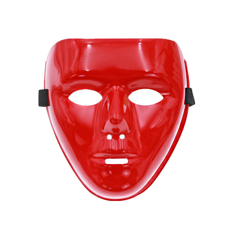 A glossy, red plastic mask with cutouts for eyes, nose holes, and a mouth slit. Black elastic straps are attached on the sides for securing the mask.